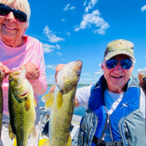 man and woman holding four fish on a boat in minnesota